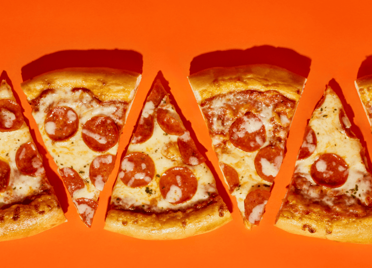 slices of pepperoni pizza in a horizontal row